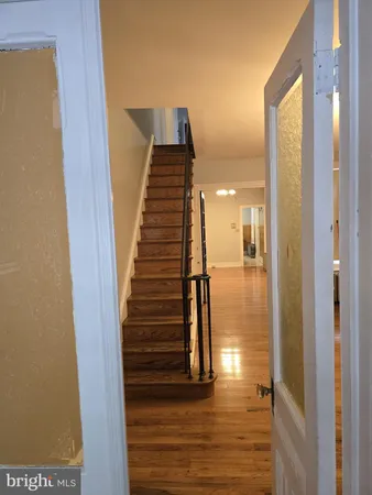a view of entryway and hall with wooden floor