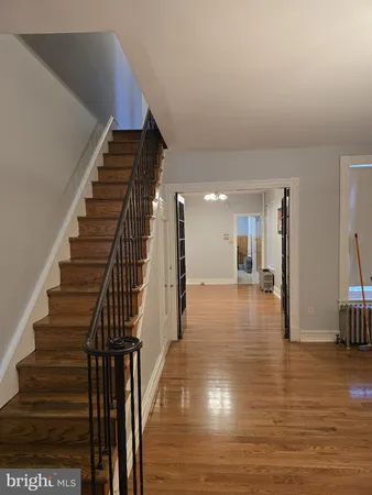 a view of entryway and hall with wooden floor