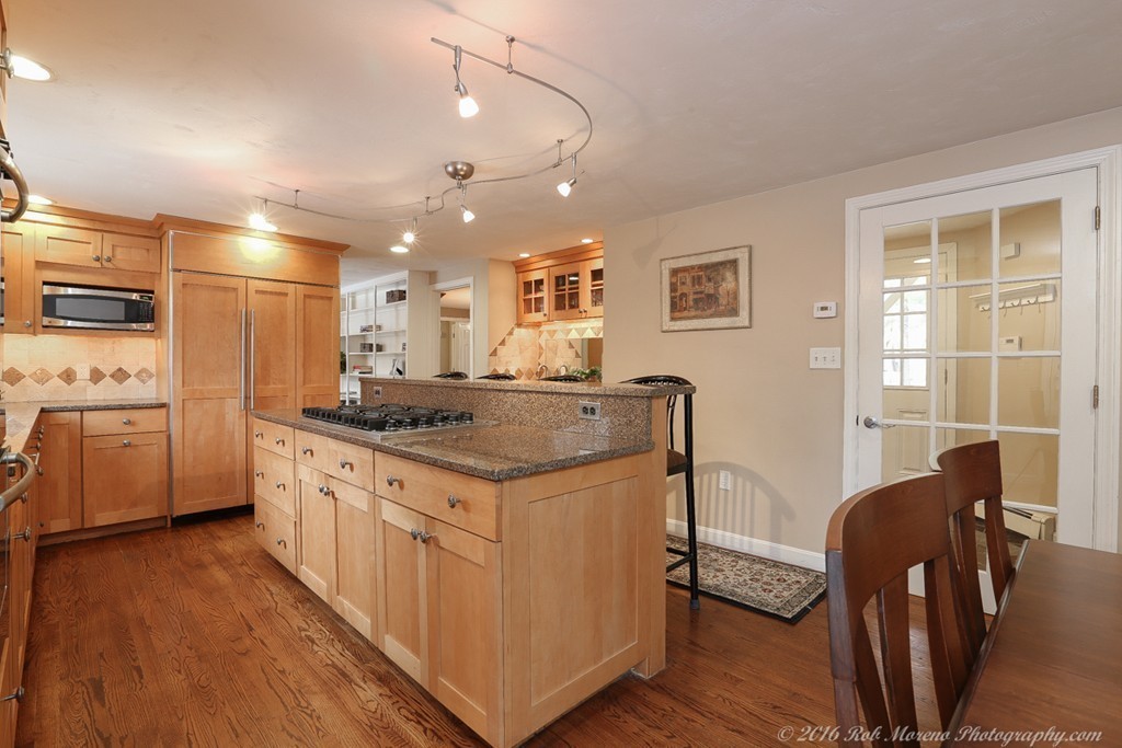32 Olde Farms Road Boxford, MA 01921 - Photo 6 of 28 a kitchen with kitchen island granite countertop a sink cabinets and wooden floor