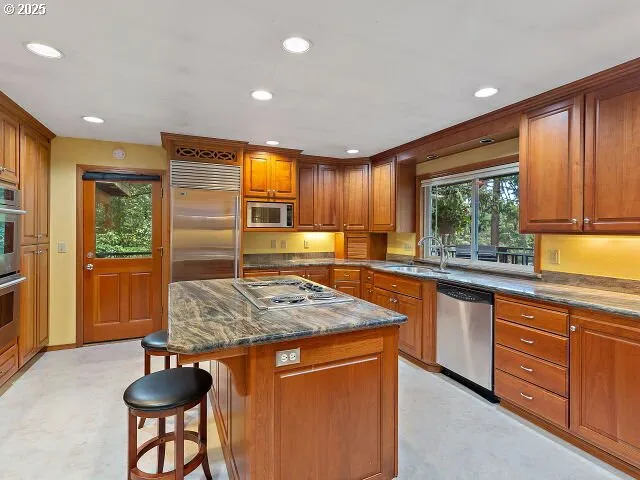 a kitchen with a stove a sink and a refrigerator