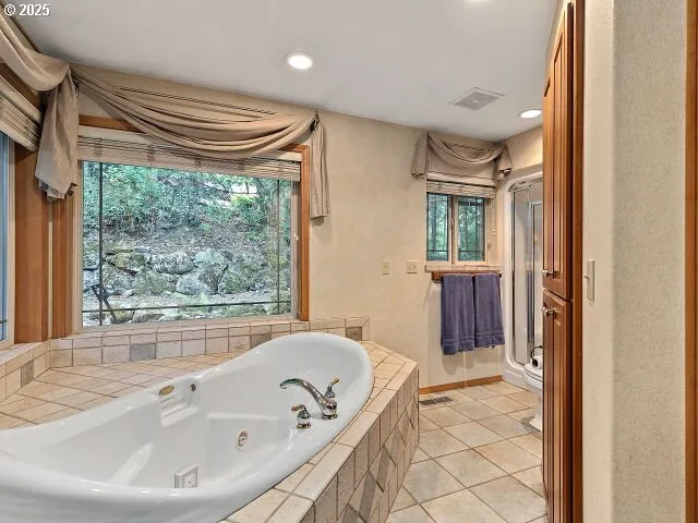 a bathroom with a tub and a sink