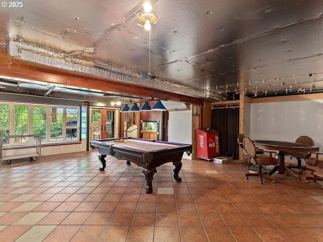 a room with pool table and window