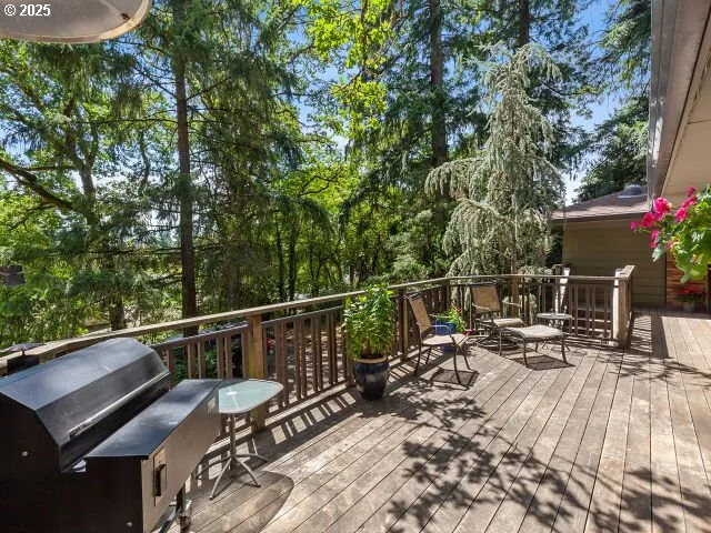 a view of balcony with two chairs and wooden fence