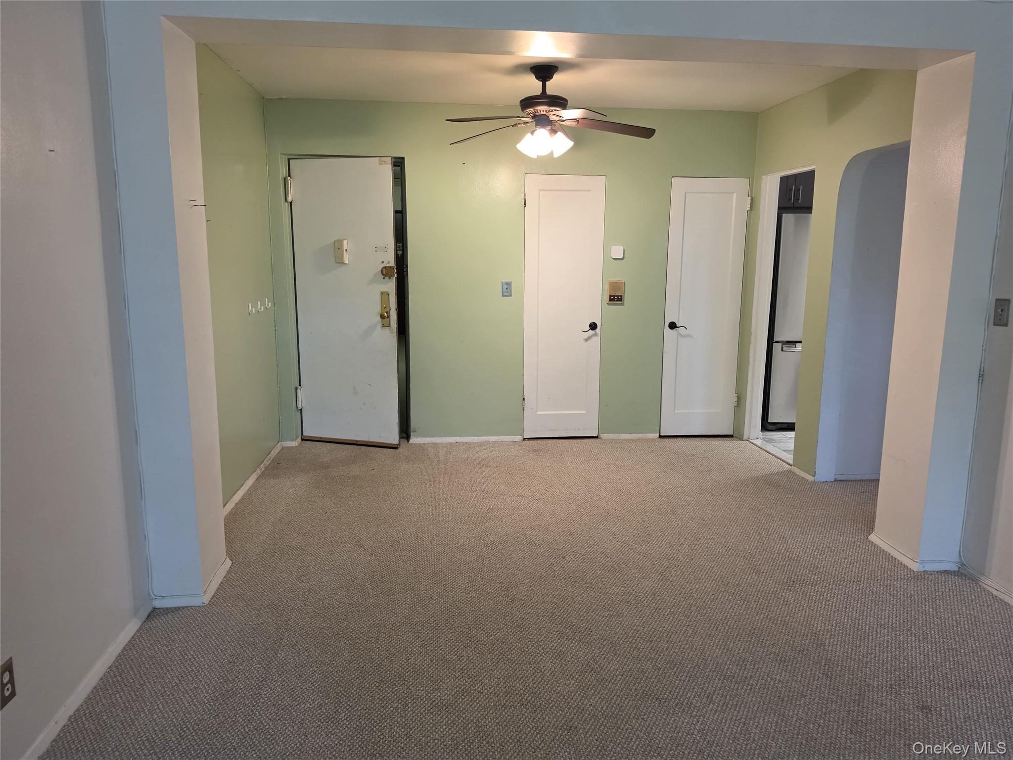 765 Bronx River Road, Unit 3F Bronxville, NY 10708 - Photo 4 of 28 Carpeted room featuring light green walls, a ceiling fan with light fixture, and white trim