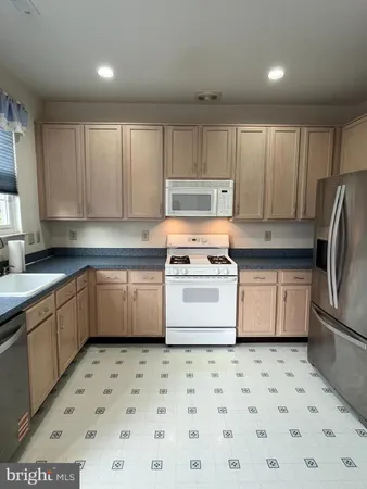 a kitchen with a stove a sink and a refrigerator