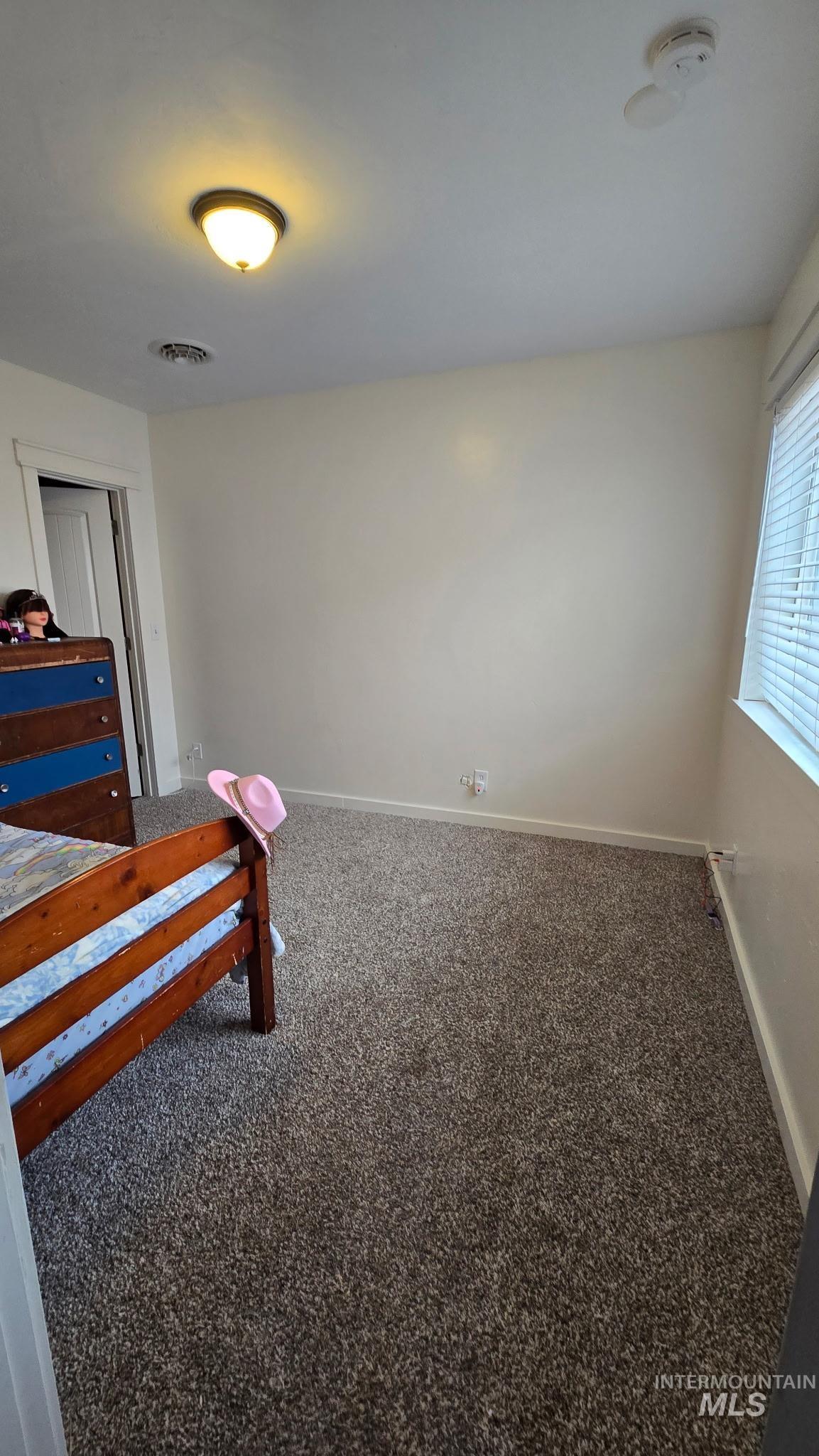 802 South 9th Street Rupert, ID 83350 - Photo 25 of 50 Bedroom with baseboards and dark colored carpet