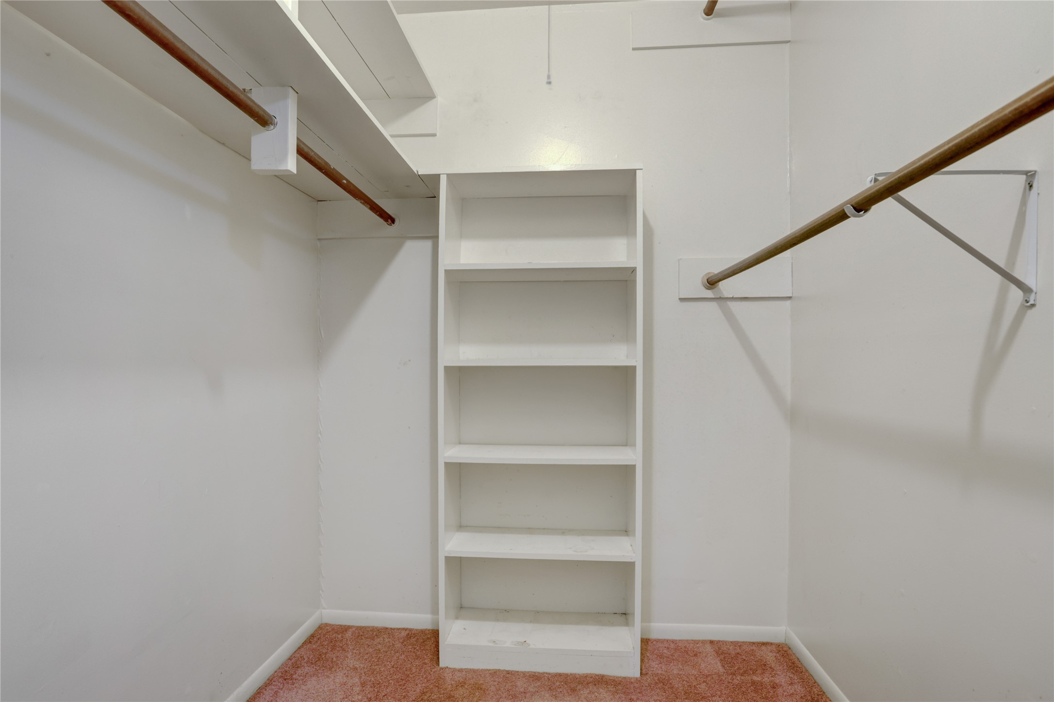 105 Ridgemont Drive Alvin, TX 77511 - Photo 18 of 30 a view of walk in closet with empty racks