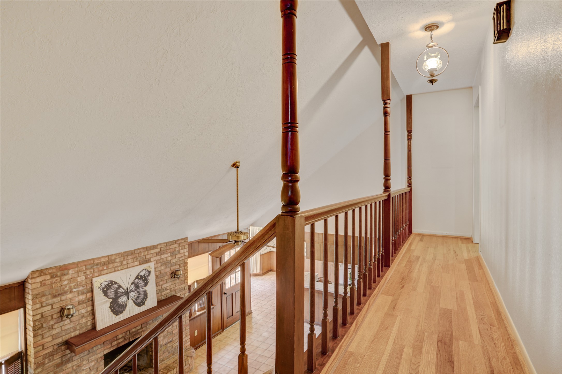 105 Ridgemont Drive Alvin, TX 77511 - Photo 19 of 30 a view of a hallway with wooden floor and stairs