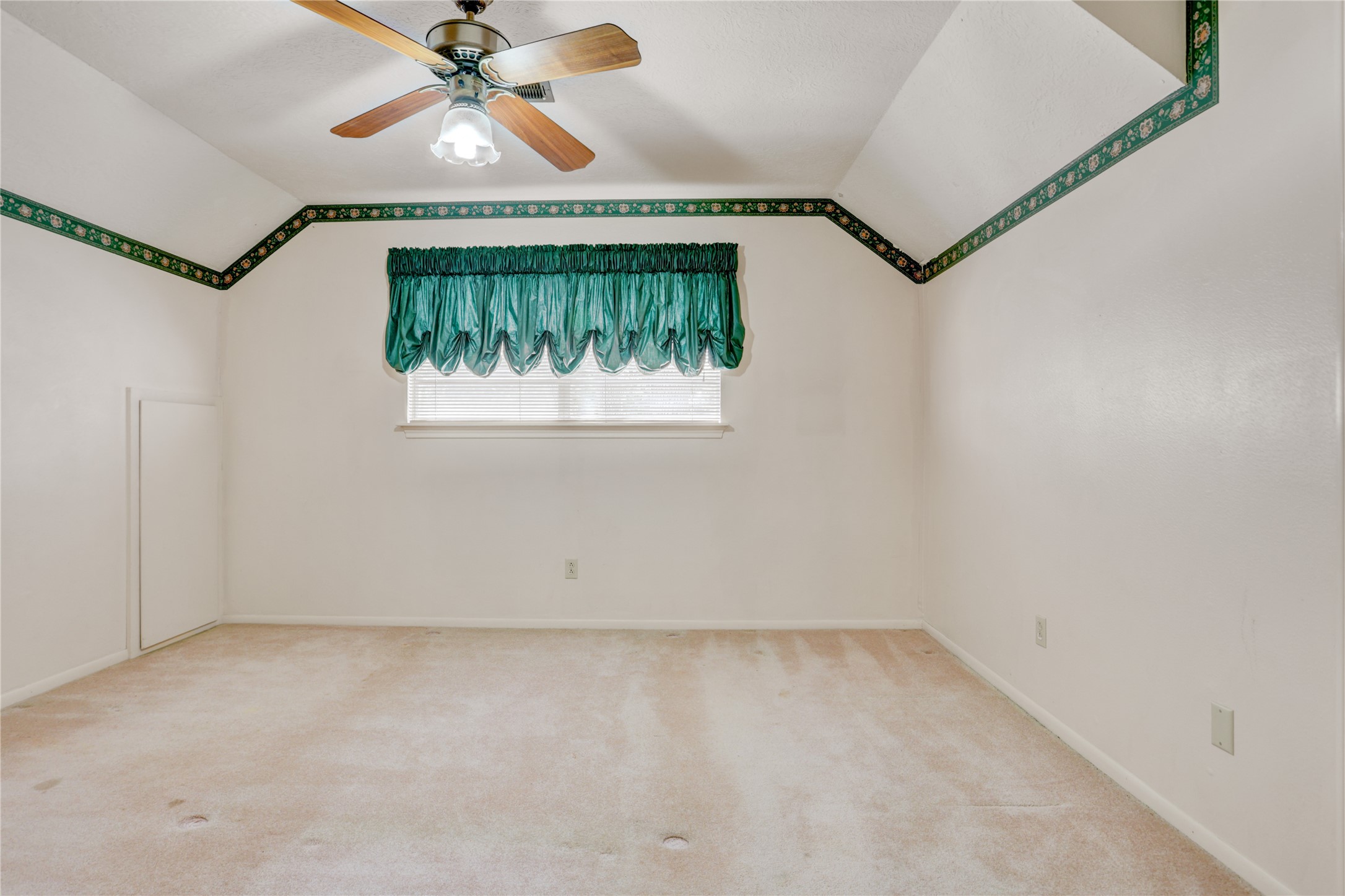 105 Ridgemont Drive Alvin, TX 77511 - Photo 22 of 30 an empty room with a chandelier fan and windows