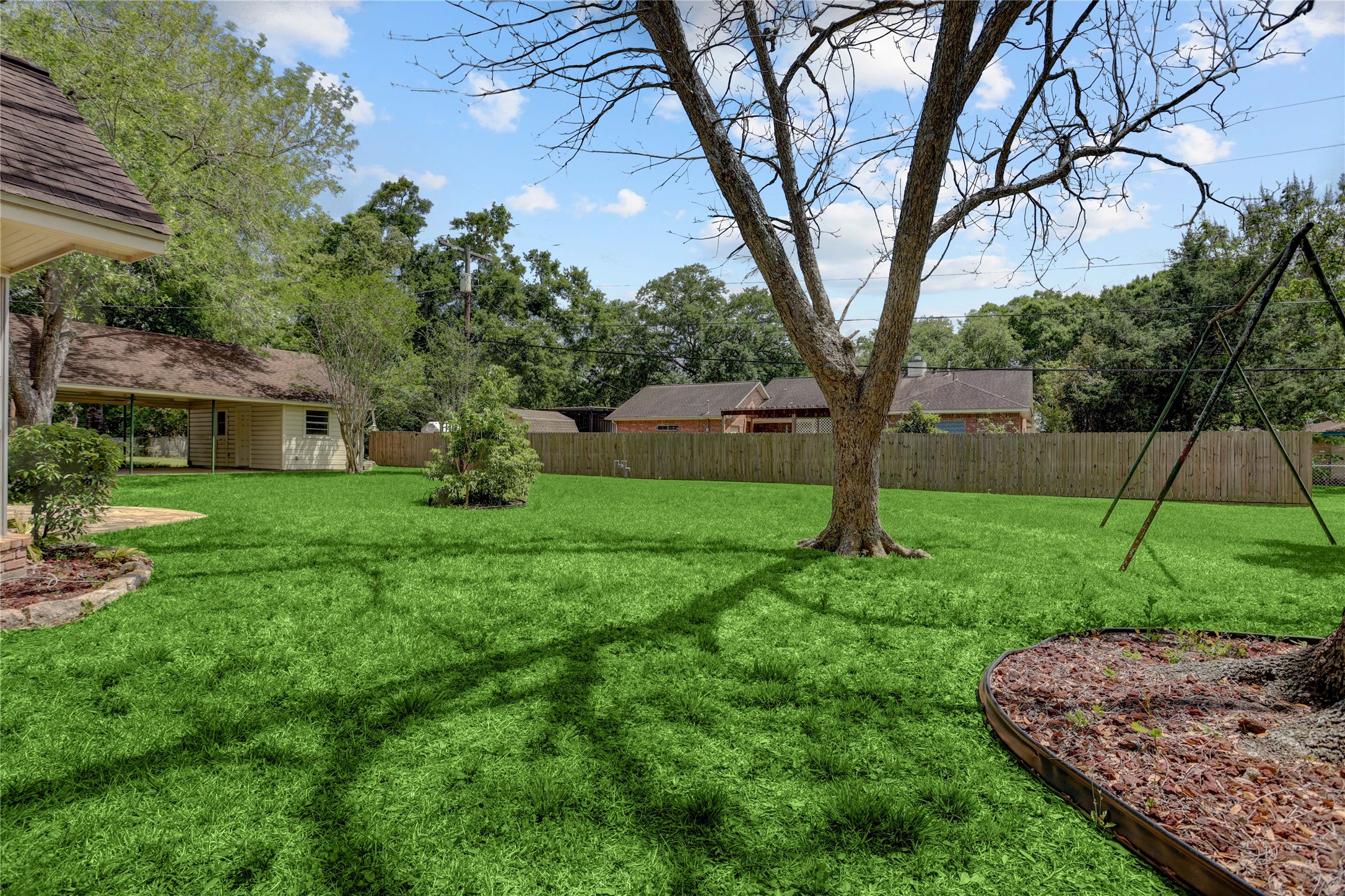 105 Ridgemont Drive Alvin, TX 77511 - Photo 25 of 30 a backyard of a house with plants and large tree