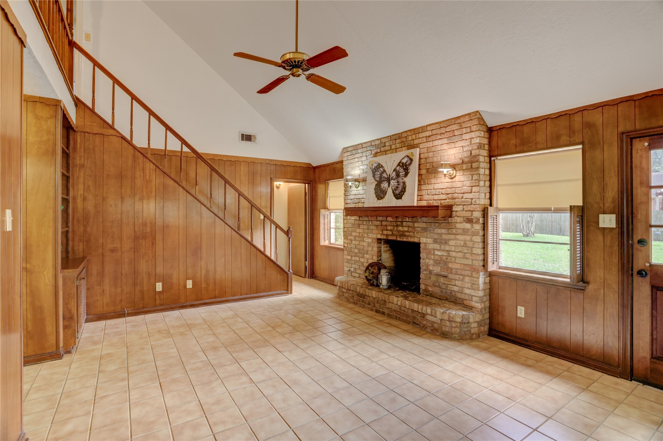 105 Ridgemont Drive Alvin, TX 77511 - Photo 8 of 30 a view of an empty room with wooden floor fireplace and a window