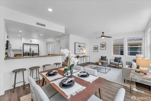 a living room with furniture kitchen view and a table