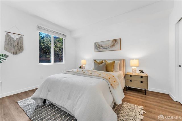 a bedroom with a large bed and a window