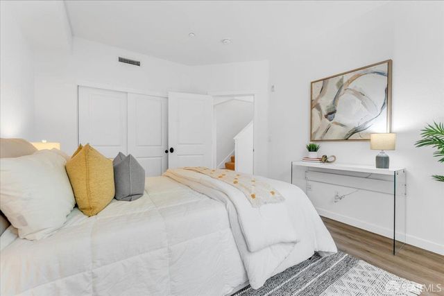 a bedroom with a large bed and a chandelier