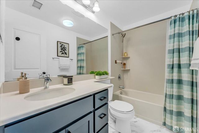 a bathroom with a granite countertop sink toilet a shower and a mirror