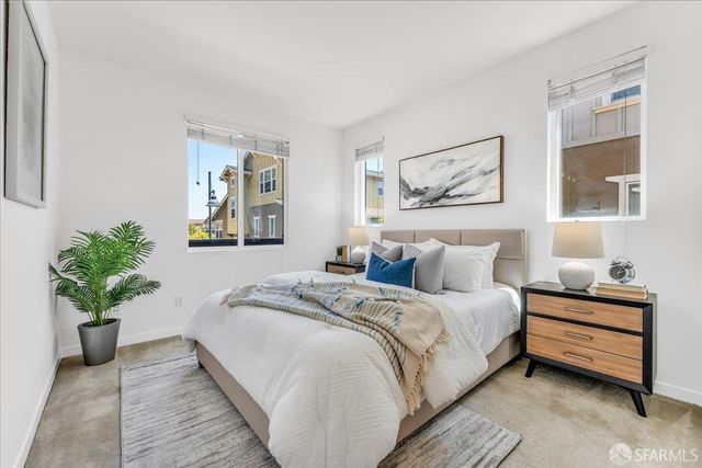 a bedroom with a bed and a painting on the wall