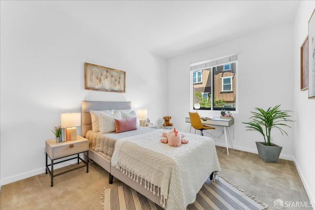 a bedroom with furniture and a potted plant