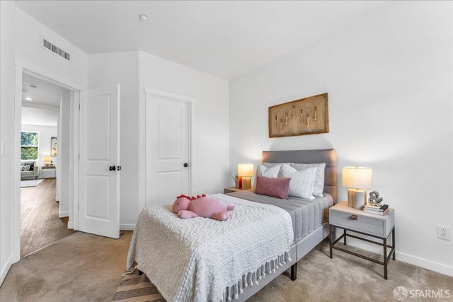 a bedroom with a bed and a painting