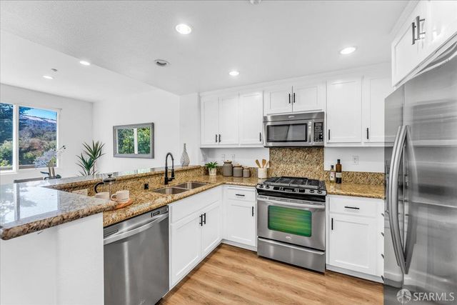 a kitchen with a sink stove and refrigerator
