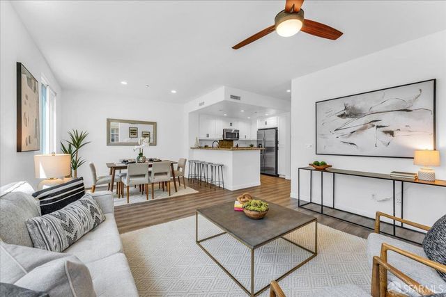 a living room with furniture and kitchen view