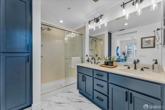 a spacious bathroom with a double vanity sink mirror and double