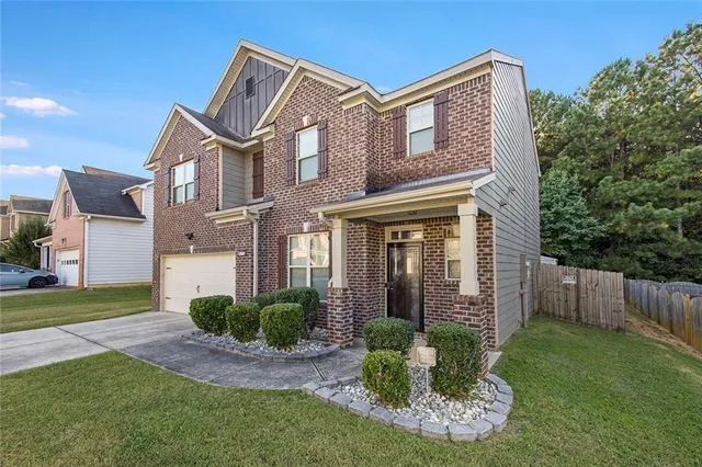 a front view of a house with garden