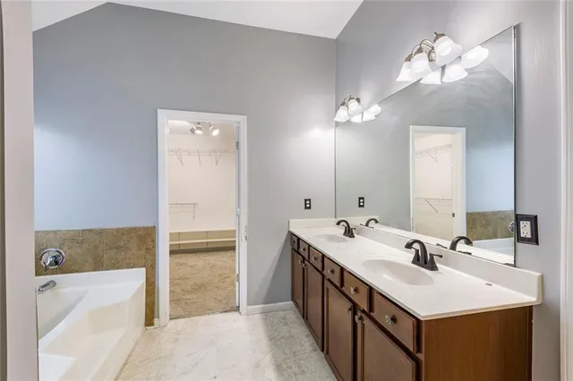 a bathroom with a sink a mirror and a bathtub