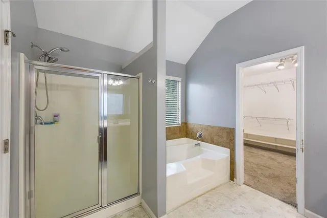 a bathroom with a tub shower and sink