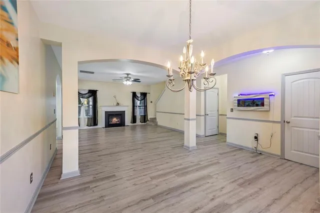 a view of a dining room with furniture wooden floor and chandelier