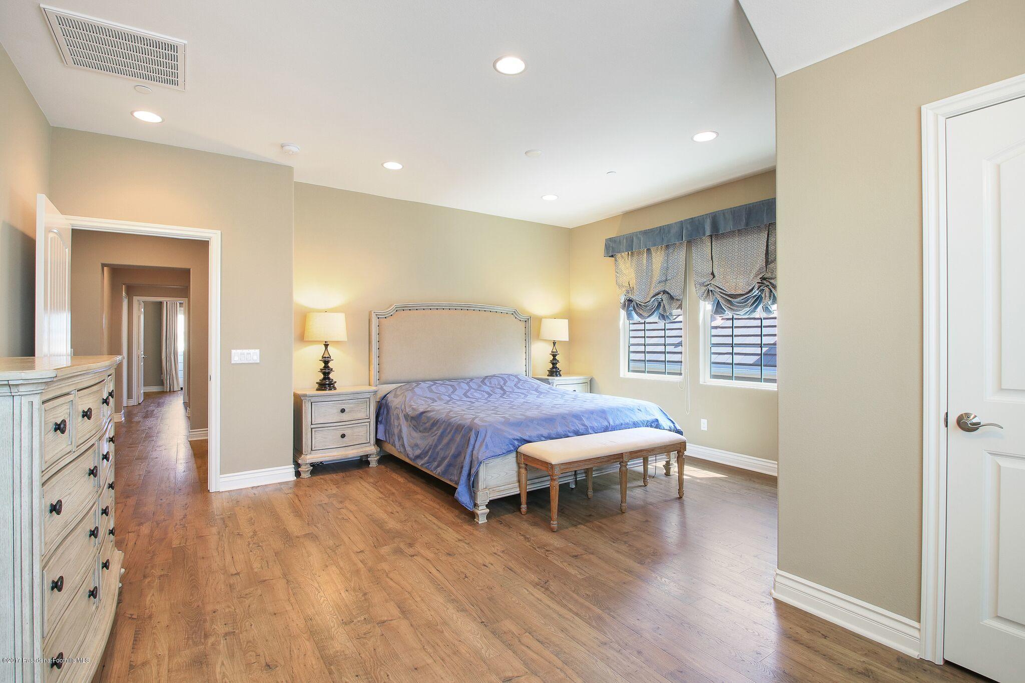 3406 Avondale Road Pasadena, CA 91107 - Photo 17 of 22 a spacious bedroom with a bed and wooden floor