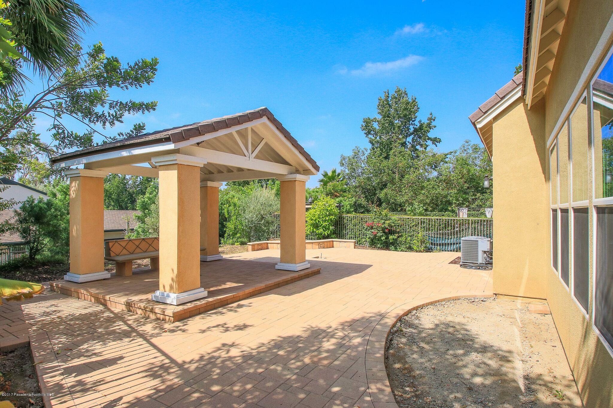 3406 Avondale Road Pasadena, CA 91107 - Photo 22 of 22 a patio with table and chairs and potted plants