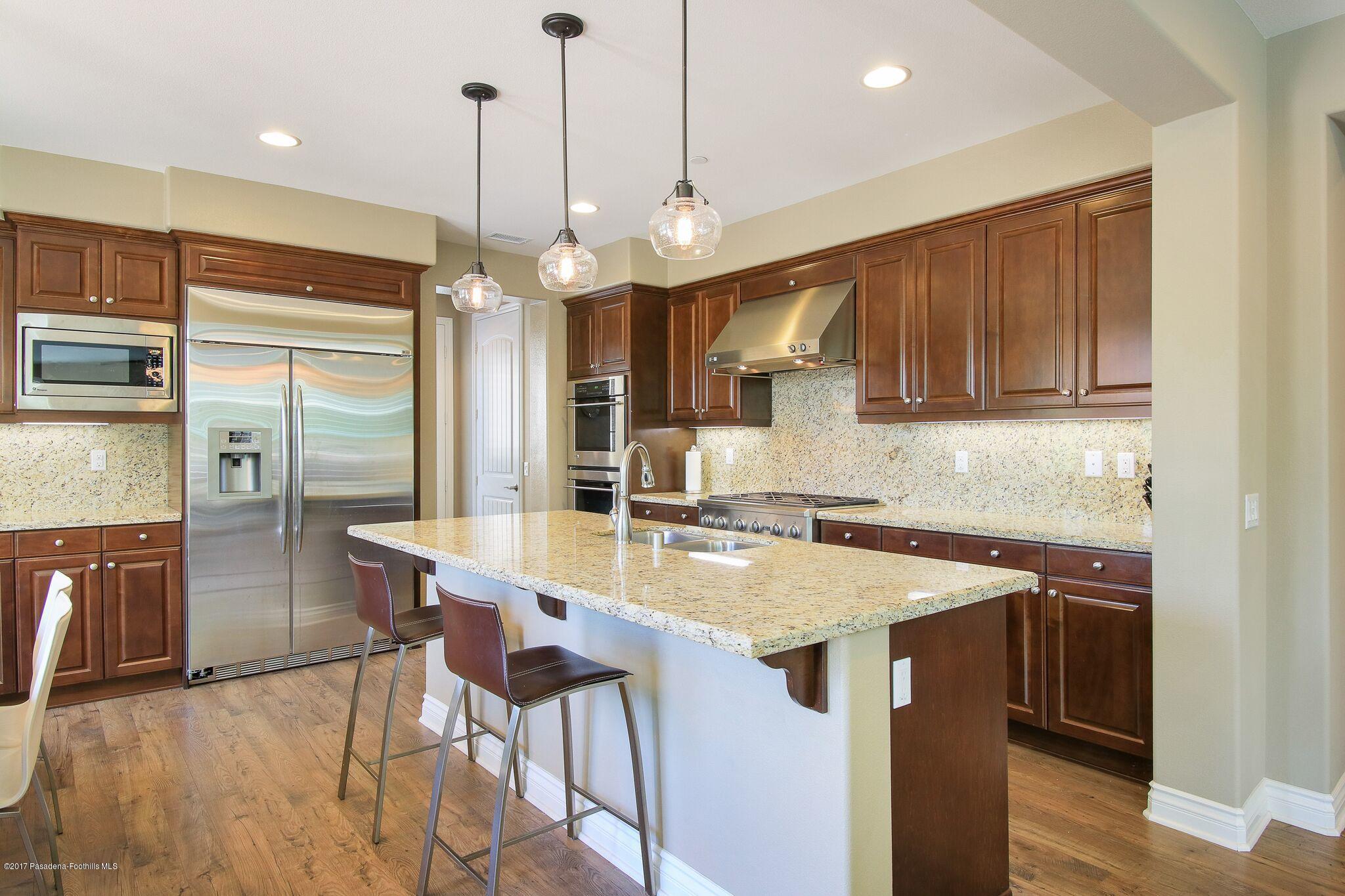 3406 Avondale Road Pasadena, CA 91107 - Photo 10 of 22 a kitchen with stainless steel appliances granite countertop a sink a stove a refrigerator and island with wooden floor