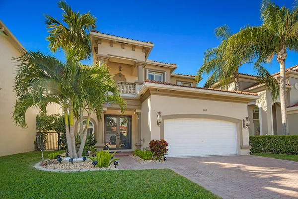 a front view of a house with a yard and garage