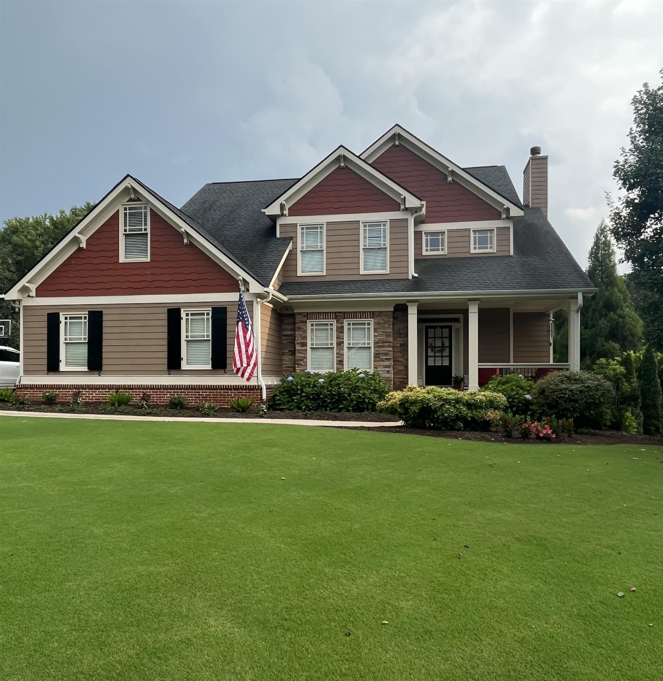 a front view of a house with a garden