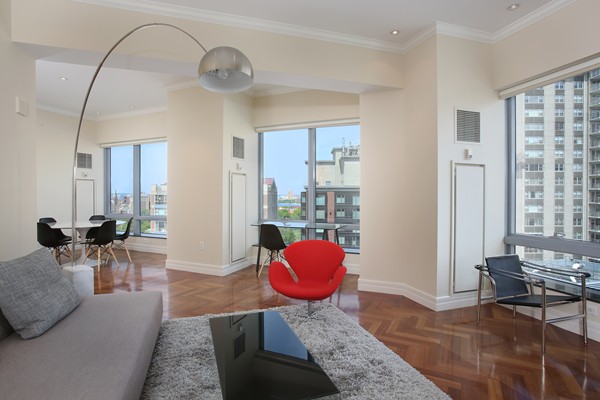 a living room with furniture and wooden floor