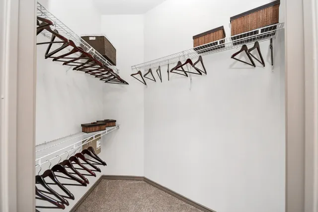 a large kitchen with stainless steel appliances kitchen island granite countertop a large counter top and a stove