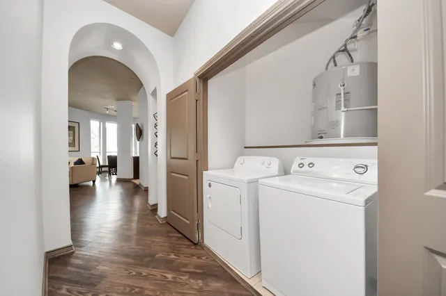 a living room with lots of furniture and a wooden floor