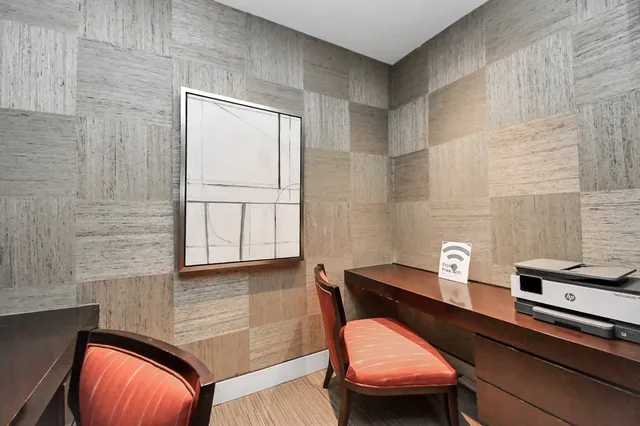 a living room with furniture wooden floor and a flat screen tv