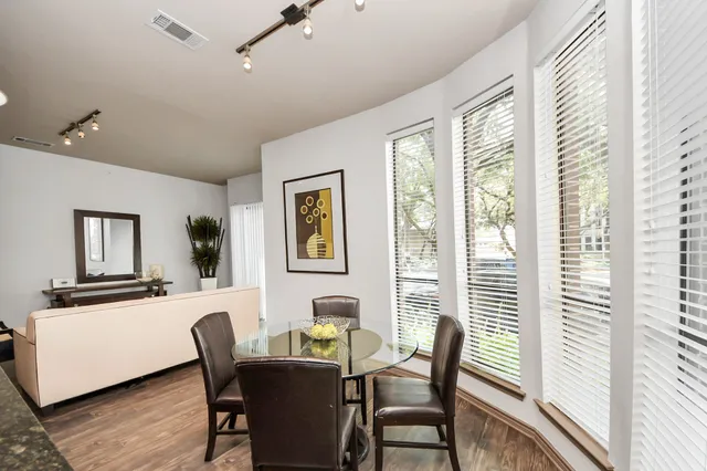 a bedroom with a bed a chandelier and a window