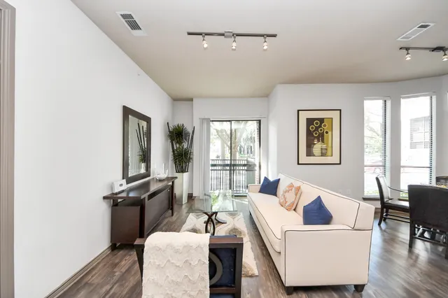 a bathroom with a granite countertop sink a mirror and a bathtub