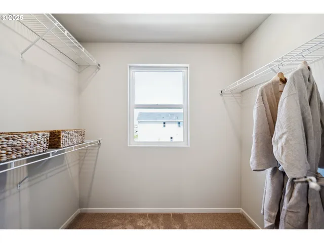 a bedroom with a bed a lamp and potted plant