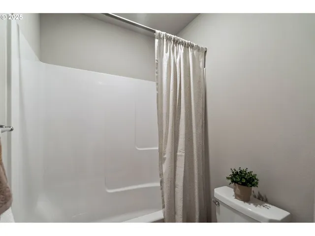 a bathroom with a bathtub shower