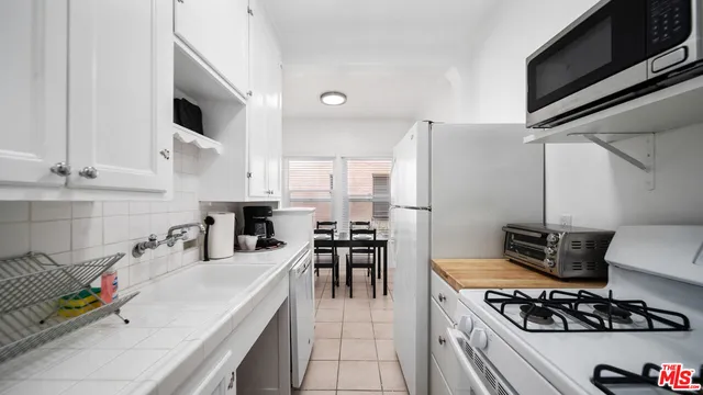 a kitchen with stainless steel appliances granite countertop a stove and a sink