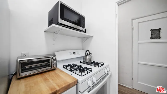 a kitchen with a stove and a microwave