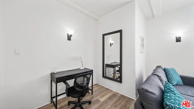 a view of a workspace with furniture and wooden floor