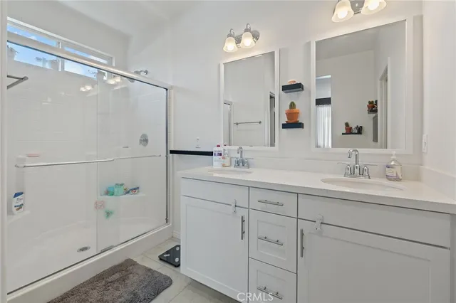 a bathroom with a shower sink and mirror