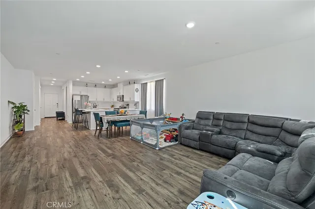 a living room with furniture and kitchen view