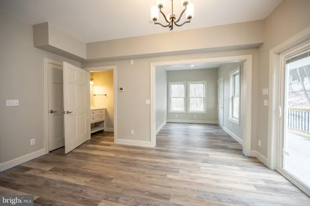 a spacious bathroom with a double vanity sink a mirror and shower