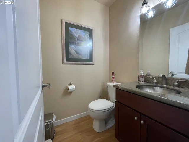 a bathroom with a toilet a sink and mirror