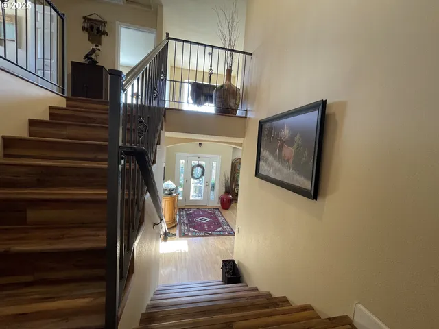 a view of entryway and hall with wooden floor